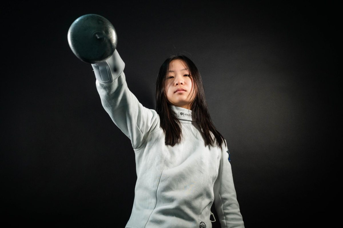 By successfully balancing academics and fencing, ninth grader Ella Nguyen stands out not only for her skill but for her persistence and openness to advice from her coach, peers and even her brother.