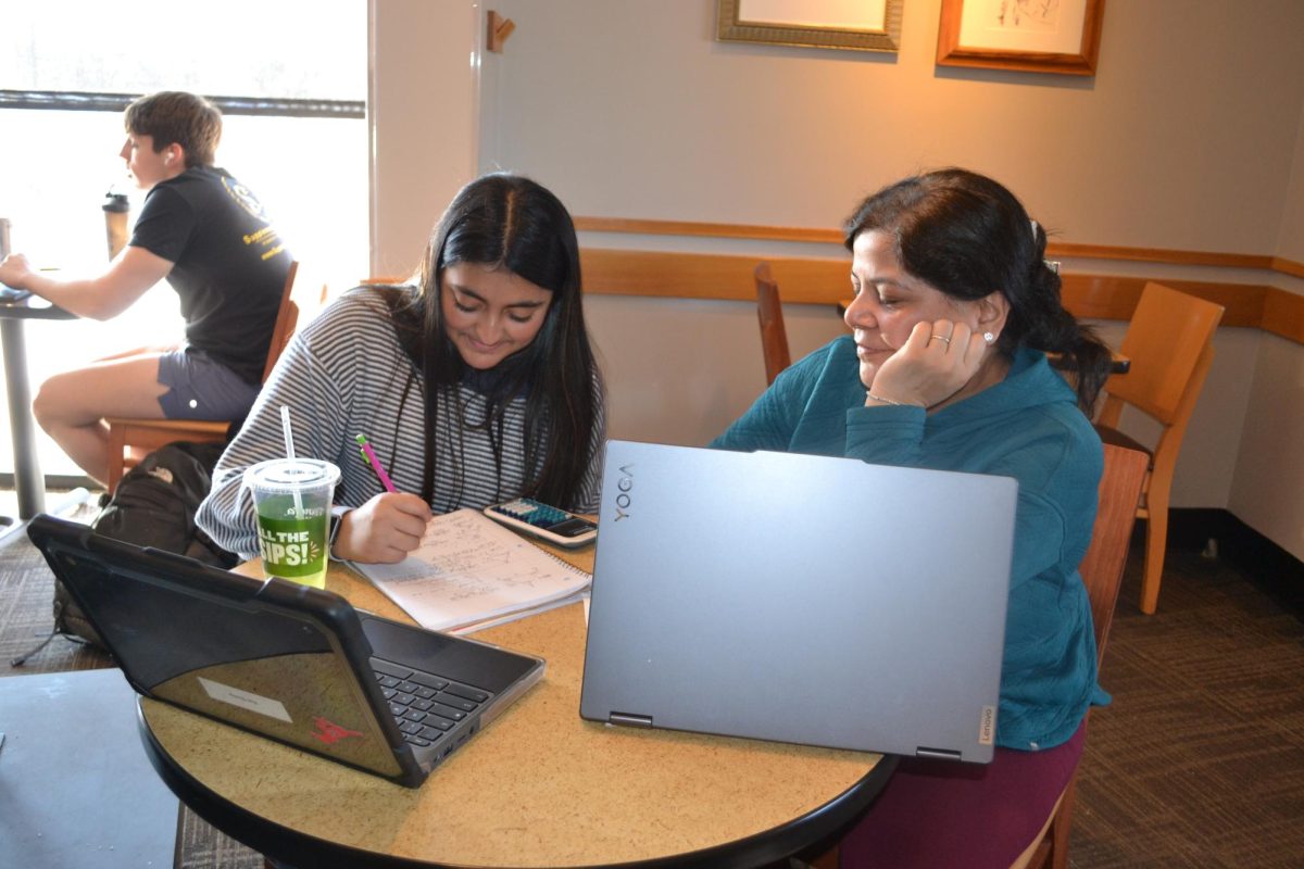 Shivali Chhabra, math professor, helps a student during her tutoring class at Panera. “I used to teach at my house, but it eventually got too distracting, so we moved to Panera,” Chhabra said. 