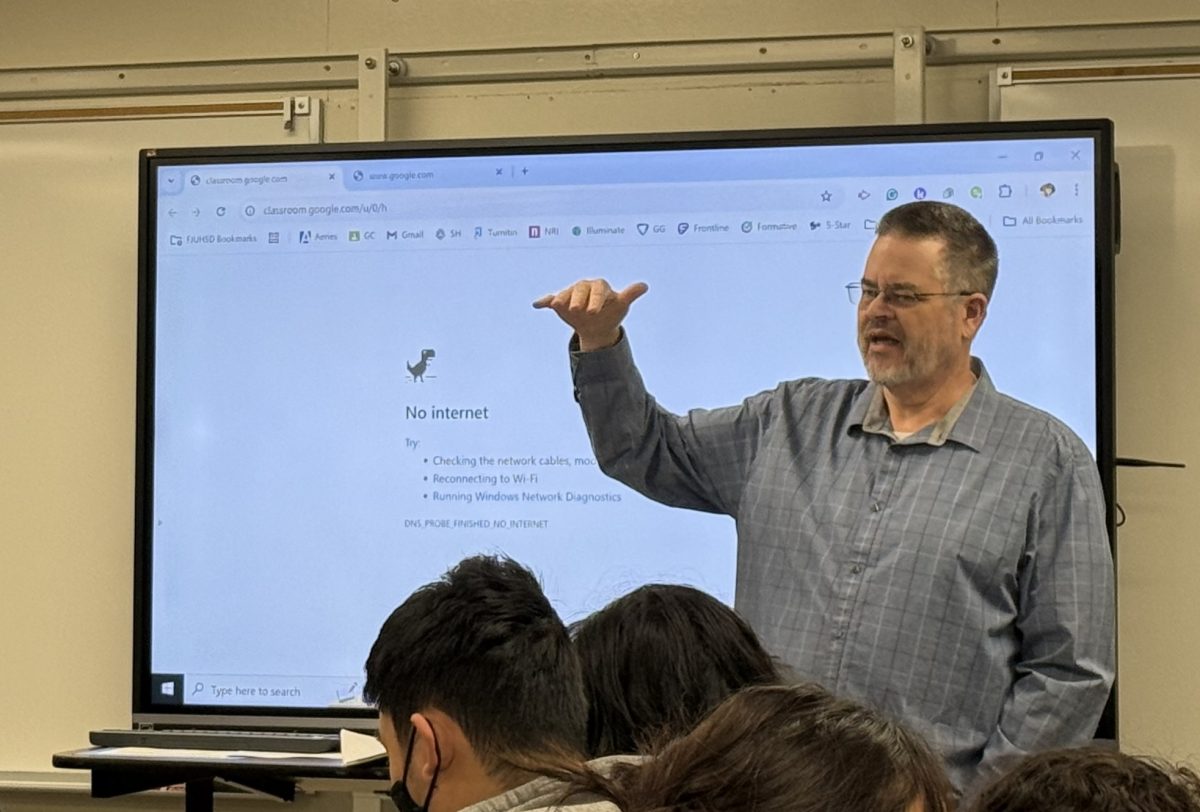 English long-term substitute teacher Tom Wiegman lectures during first-period Advanced Placement English Literature class today in Room 32 while the ViewSonic monitor behind him shows no internet access. Sunny Hills and all campuses in the Fullerton Joint Union High School District could not access the internet for the whole school day though it was restored within an hour after school.