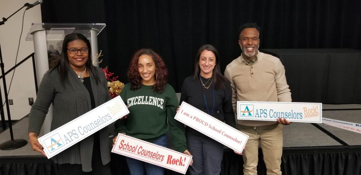 Lamar Young [right] stands with fellow counselors. Young served as a counselor for 15 years at Midtown, providing critical support for students and parents. 