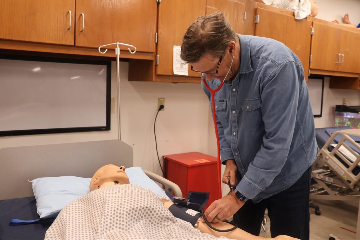Coppell High School health science teacher and HOSA advisor Bill Borowski demonstrates taking blood pressures for his students on March 6. Borowski makes a profound impact on the CHS healthcare community and is selected The Sidekick’s Teacher of the Issue. Photo by Emmalee Jittasupo