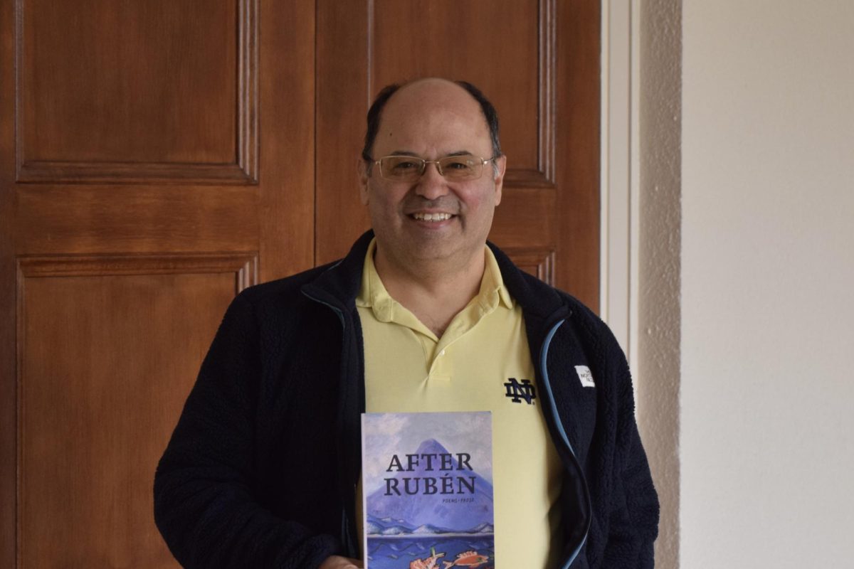 Francisco Aragón ’84 poses for a photo with his poetry book, “After Ruben.”