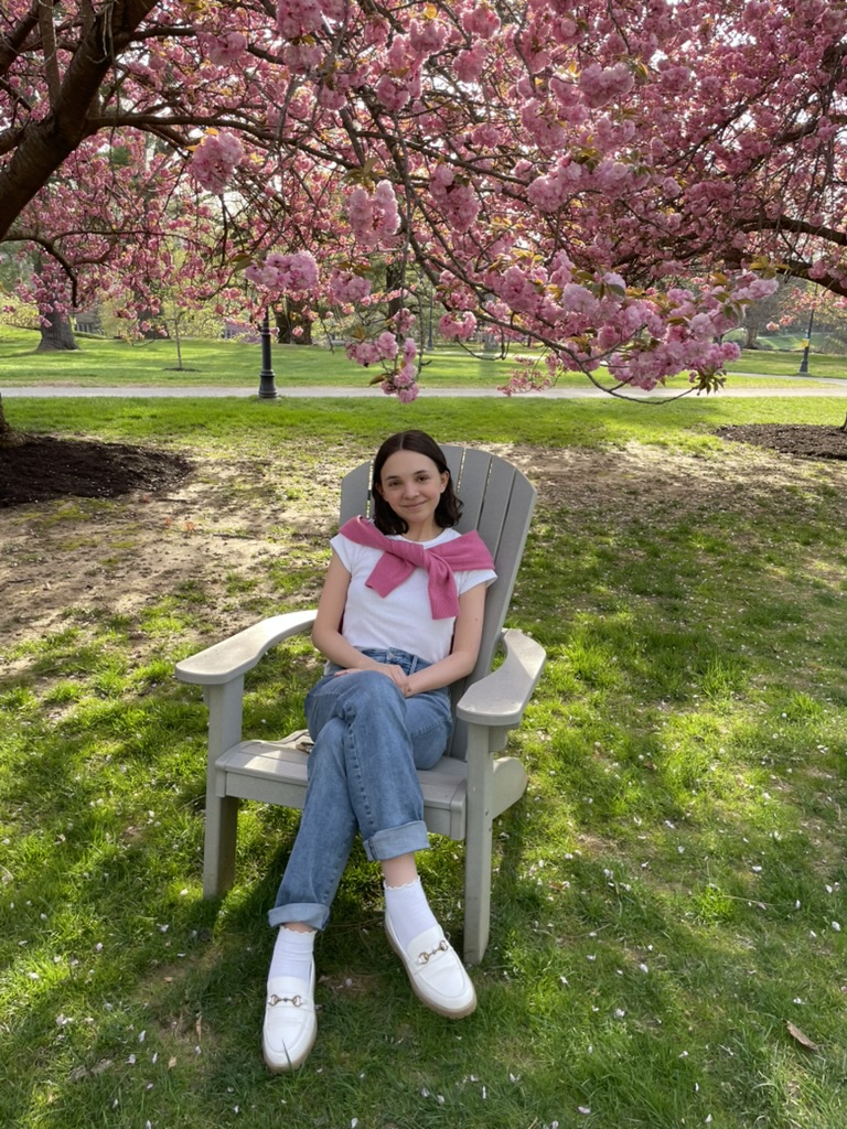 Sarah Schlapp relaxes on a lawn in front of Bryn Mawr College, the school she will be attending in the fall. Schlapp chose Bryn Mawr because of her positive experience feeling valued and included in classroom discussions in a predominantly-female environment. 