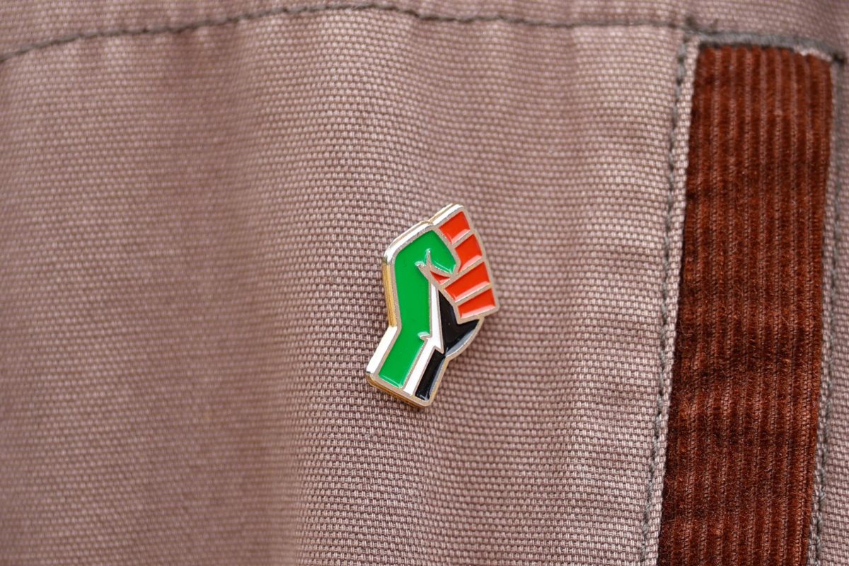 A pin is displayed on MU senior Ian De Smet’s jacket as he poses in Speakers Circle on Saturday, April 26, 2025, in Columbia, Missouri "There's little elements here and there in how I present myself that helps bridge that initial hardest challenge of stepping out of your comfort zone," De Smet said. 