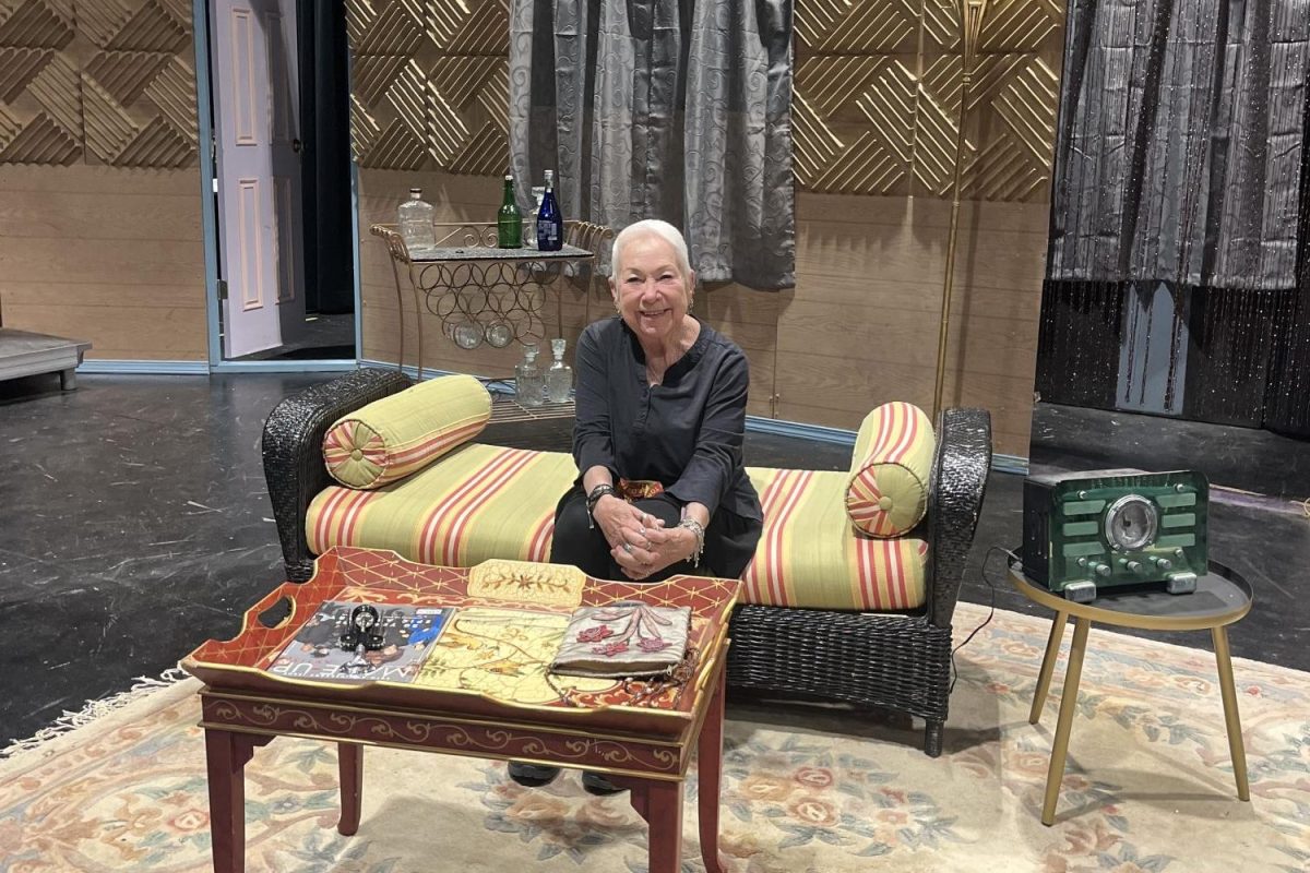 Theater teacher Marinee Payne sits on the set of "Lend Me a Tenor," the final TP Players production she will direct before retiring. Throughout her 32 and a half years at the school, Payne not only taught a wide range of theater classes but also developed curriculum, directed productions and created a supportive community for generations of students.