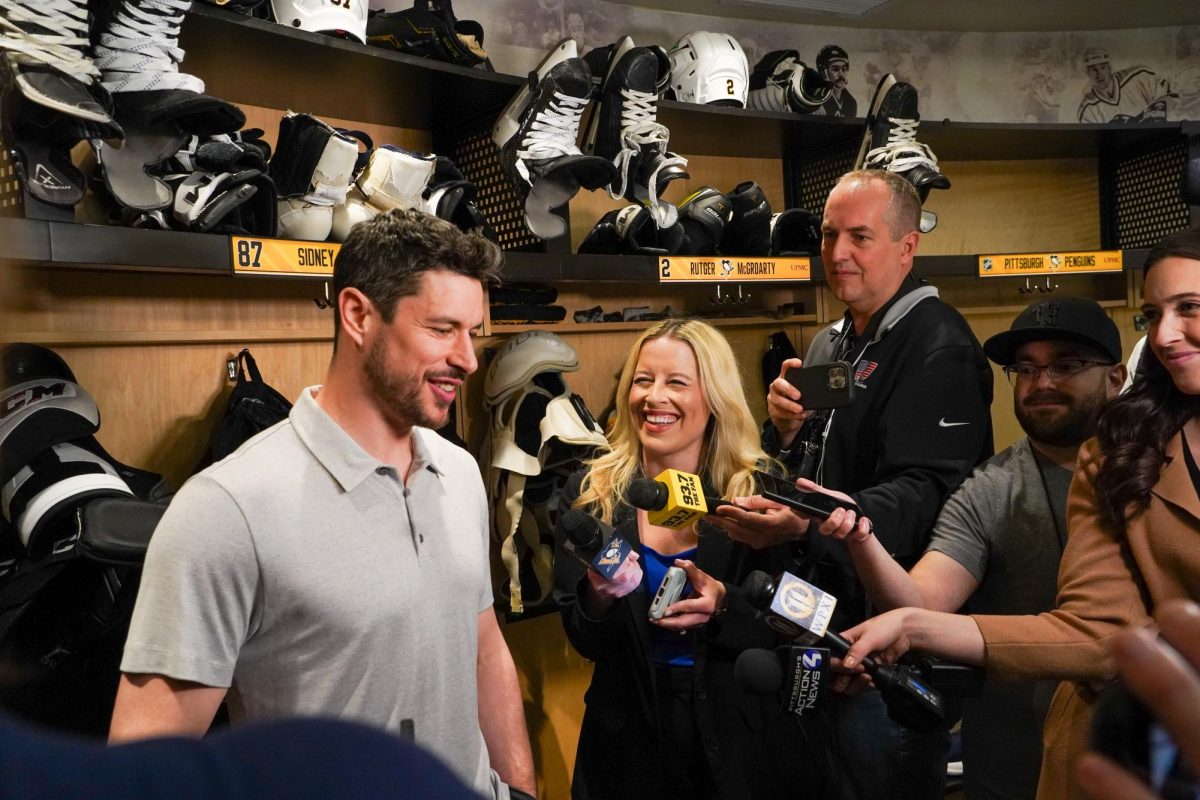 Pittsburgh Penguins team reporter Michelle Crechiolo (center) participates in an interview with star center Sidney Crosby. Photo via Michelle Crechiolo.