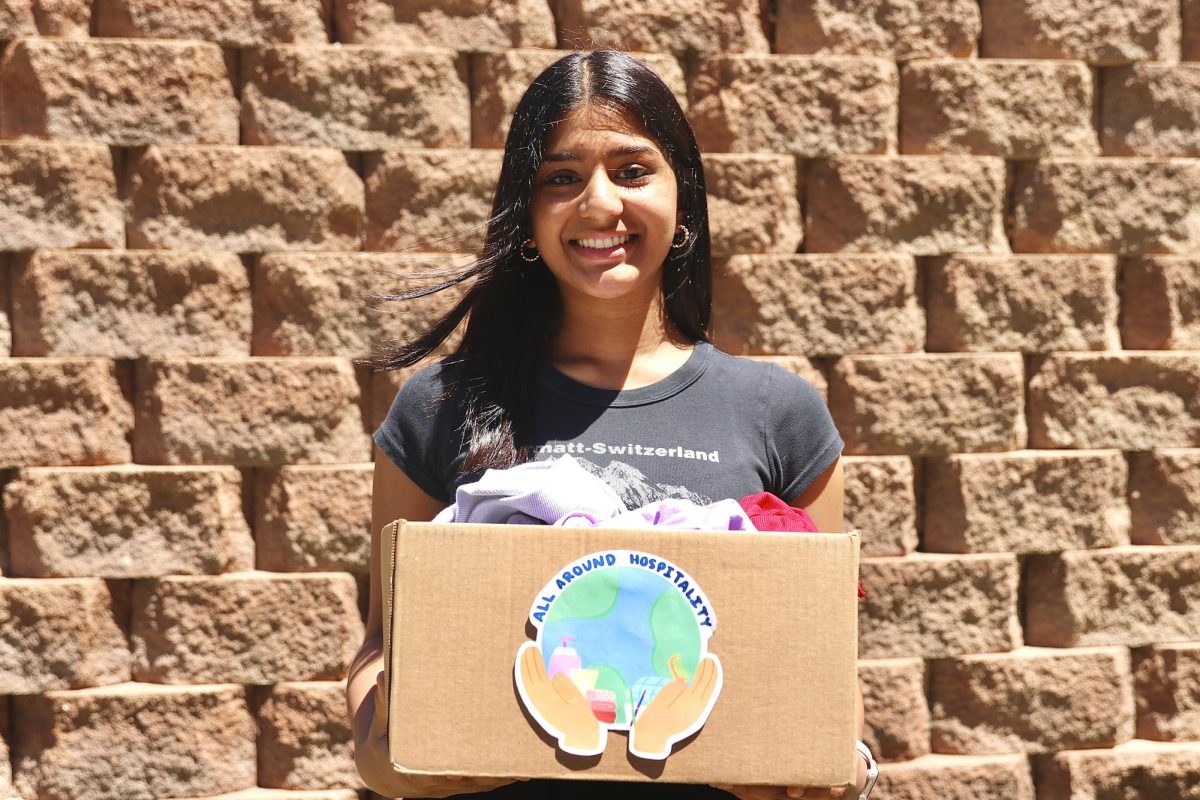 Sophomore Shay Patel poses with a box filled with clothes ready for donation. In April, her nonprofit donated 210 pounds of clothes. 