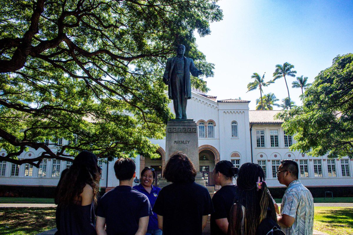 Native Hawaiian cultural historian Pualeilani Kamahoahoa leads an engaging discussion with Na Pua Onaona o Kewalo students at the oval, explaining the historical context and cultural significance of the newly installed plaque. 
