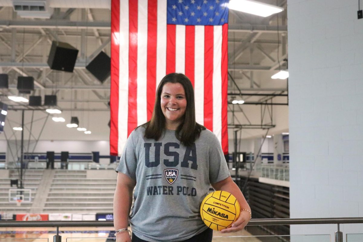 Sophomore Kinnick Kooken poses with a water polo ball in the arena. She trains with the USA Olympic Development Program along with her Texas Mavericks water polo team.