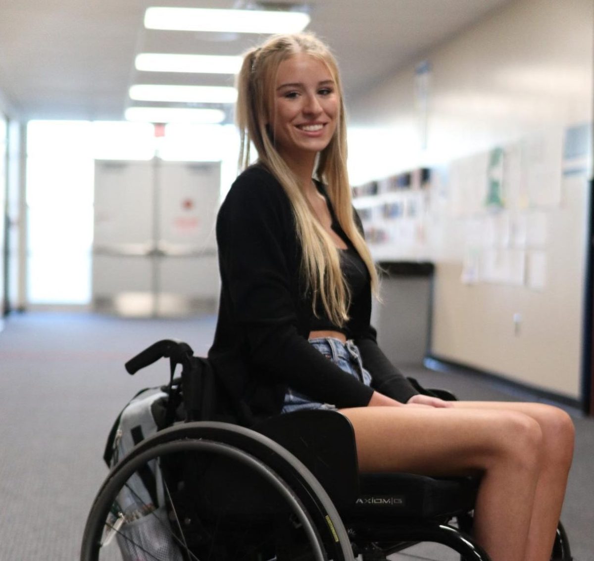 Lainey Hampton (12) poses in the hallway during the school day on April 17. Hampton recently moved to Michigan from Florida.