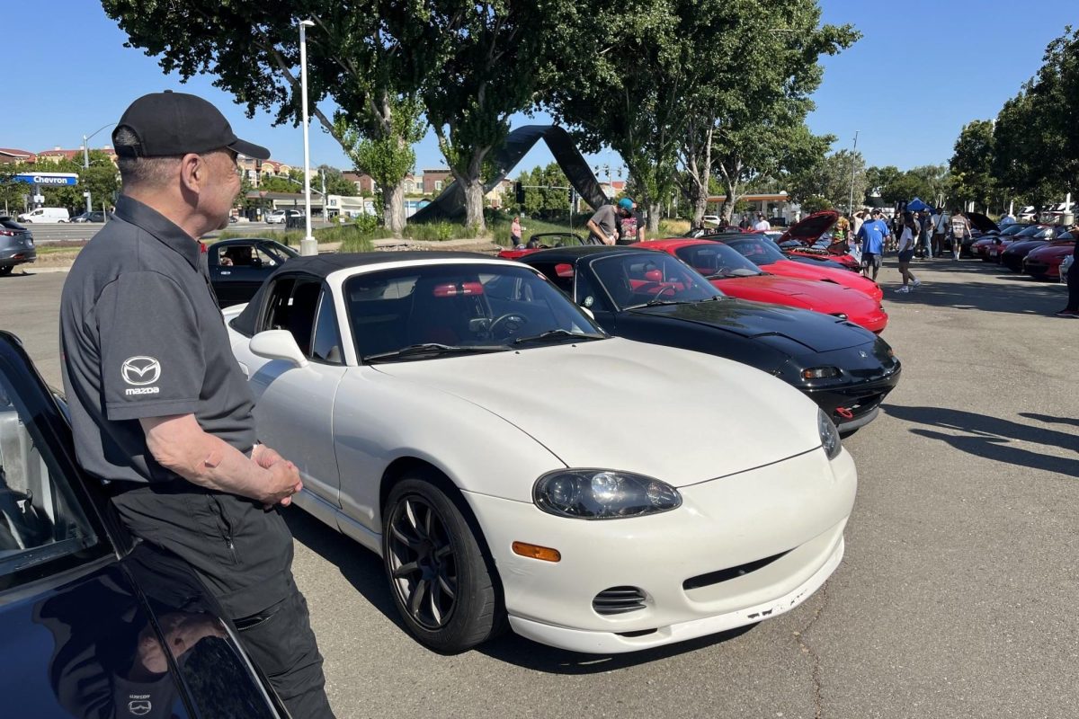 Tom Matano looks on at his Miata design at the Ohayo Roadsters Miata car meet.