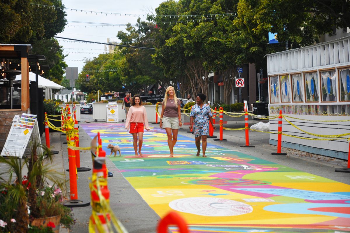 Art Bias artists Amber Smith, Deborah Shea, and Shari Bryant walk down the San Carlos centennial mural. With the purpose of honoring the city’s history, the San Carlos centennial mural is a massive feat, displaying the result of talent, research, and collaboration within the artwork. The artists received help from local schools and volunteers during the first stages of painting. “In the beginning, we allowed people to sign up as volunteers. We allowed them to do the primer and the triangles. We also had a lot of kids from high school,” Smith said.