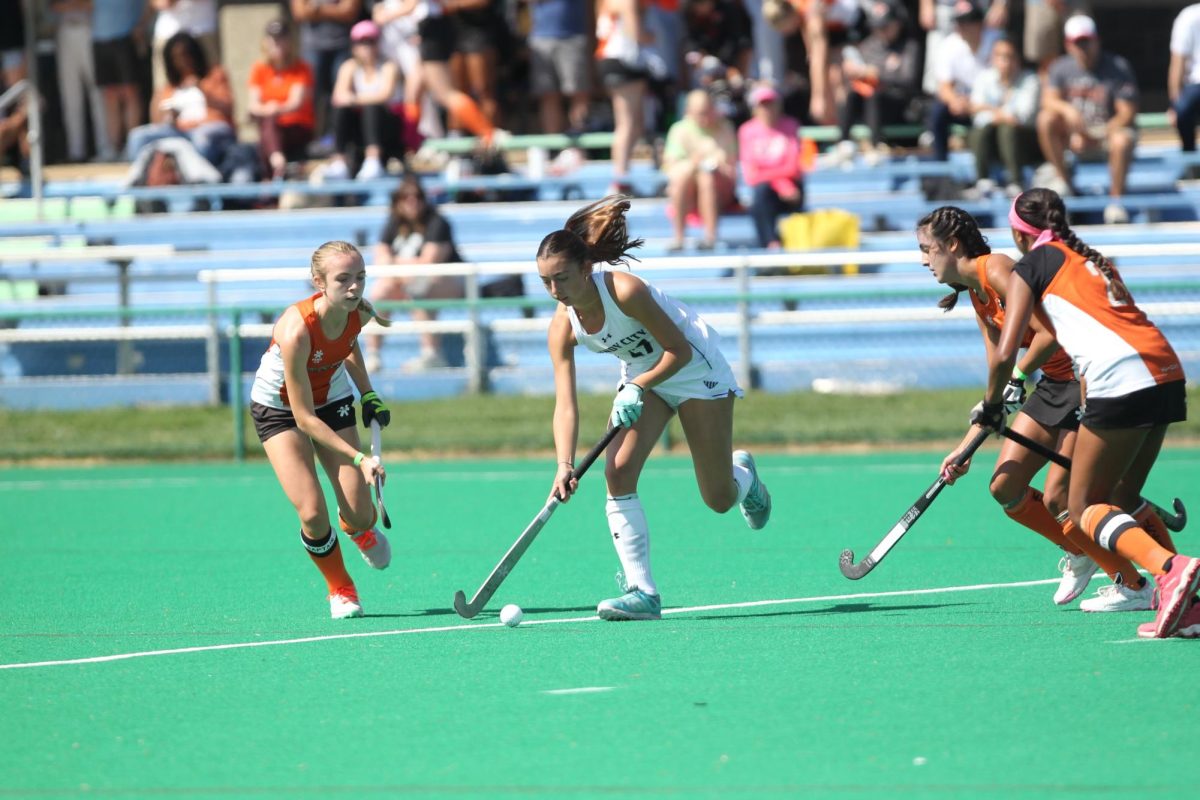 Junior Caroline Gaines (number 27) playing field hockey at a tournament with Windy City.