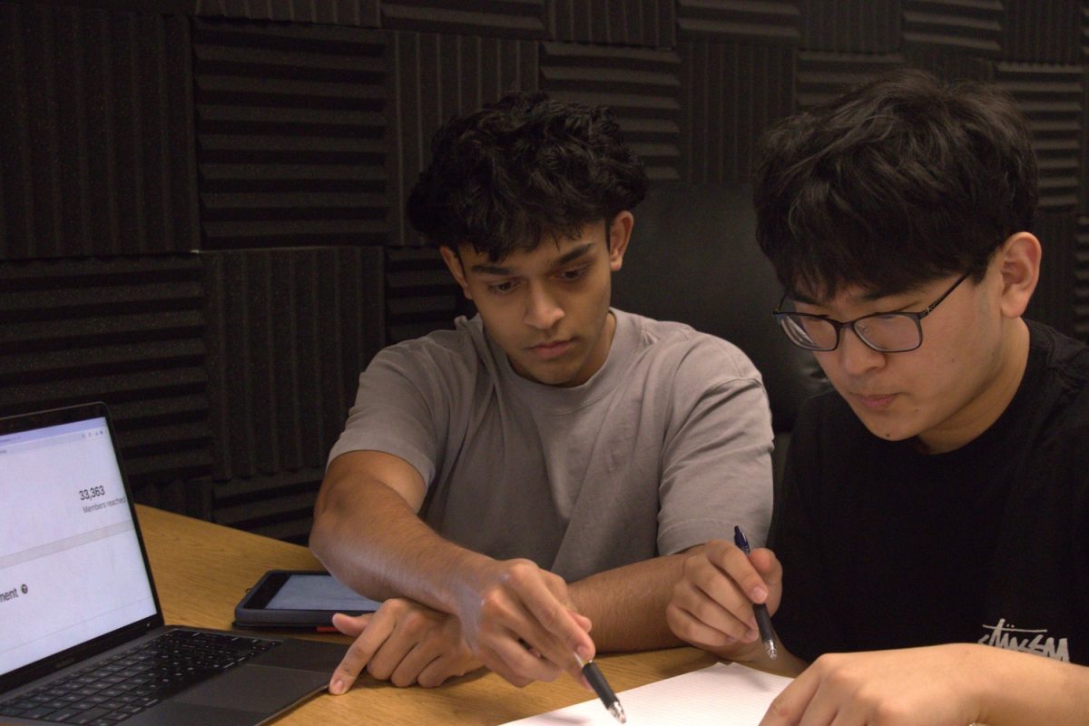 Juniors Pritam Saha (left) and Joshua Kim (right) plan interview questions for a future guest on their podcast. Pritam founded The Hustle Path to interview entrepreneurs along with Joshua as his co-host.