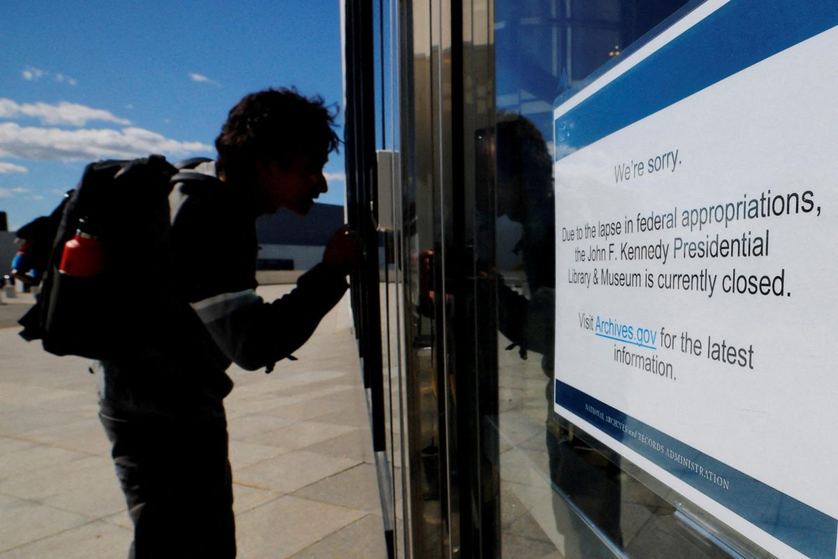 A would-be visitor looks into the John F. Kennedy Presidential Library and Museum which is closed, on the first day of a partial U.S. government shutdown, in Boston, Massachusetts, U.S., October 1, 2025.