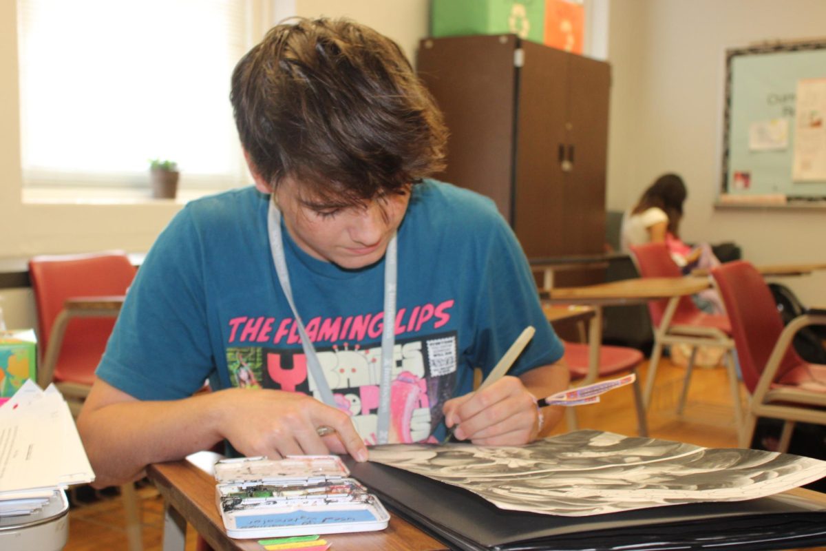 Branch Sword uses watercolors to work on Joey and Friends in his spare classtime.