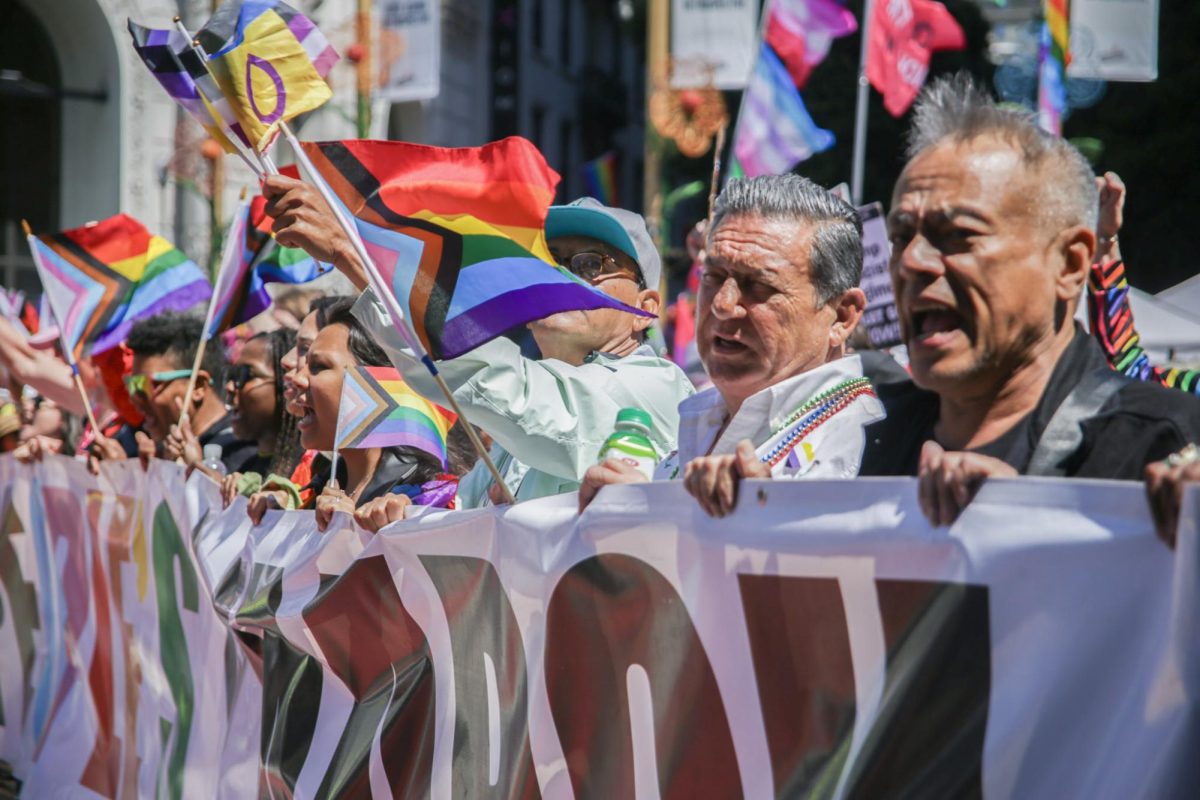 Participants of the annual San Francisco Pride Parade in June hold up a sign reading “PEOPLE’S MARCH” in protest against the Trump administration.