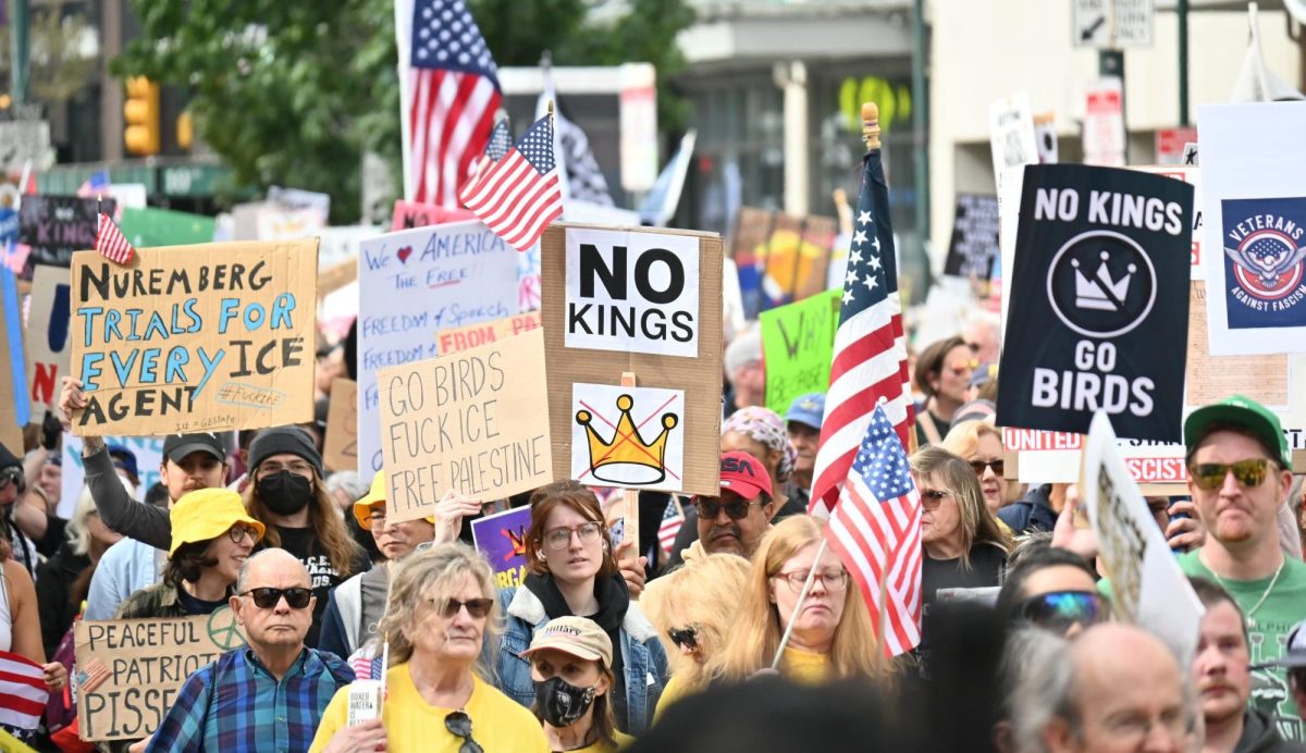 Protesters march down Market Street holding signs with a multitude of messages in protest of President Donald Trump. 