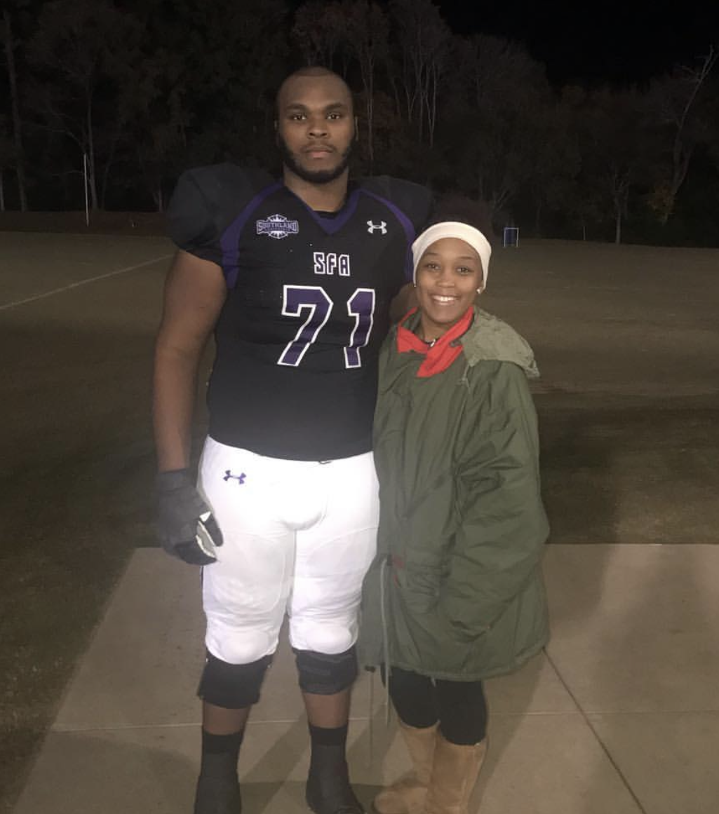 Coach Jones and Briana pose together after a game during his sophomore year playing at Stephen F. Austin University. Briana played Division 1 volleyball at SFA, and they would watch each other's games.