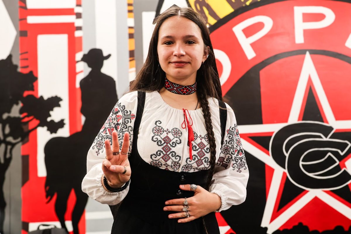 Coppell High School senior Sofiia Chernyshova holds up three fingers to represent the trident of the Ukrainian Coat of Arms's historical symbol. Chernyshova emigrated from Ukraine to the United States in ninth grade, sharing her experiences, hardships and adaptations with being an immigrant in America while simultaneously embracing her Ukrainian identity. Aditi Narayangari 