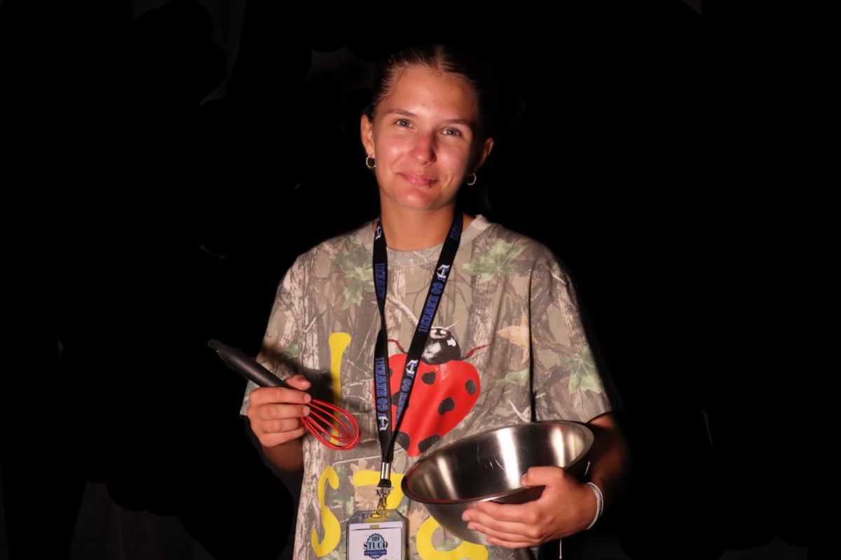 Finley poses with her measuring bowl and whisk. She bakes cookies on Sundays. 