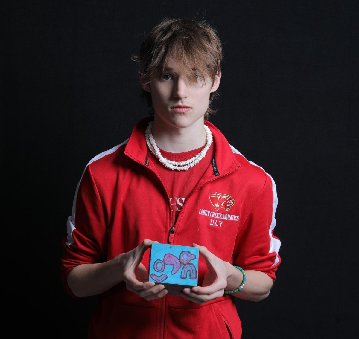 Senior Logan Day stands holding a hand-crafted box his mother, Mary Loveless Day, gifted him while in drug-addiction rehab in 2012.