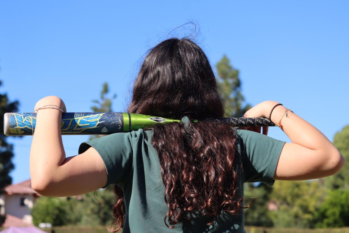 An Archer student holds a baseball bat across her shoulders. At a young age, many female baseball players abandon their sport due to discouragement from coaches and a lack of professional opportunity, said athlete Michelle Roche. The Women’s Professional Baseball League (WPBL) intends to challenge this occurrence, and will commence its inaugural season in Aug. 2026, featuring four teams: Boston, New York, San Francisco and Los Angeles. 