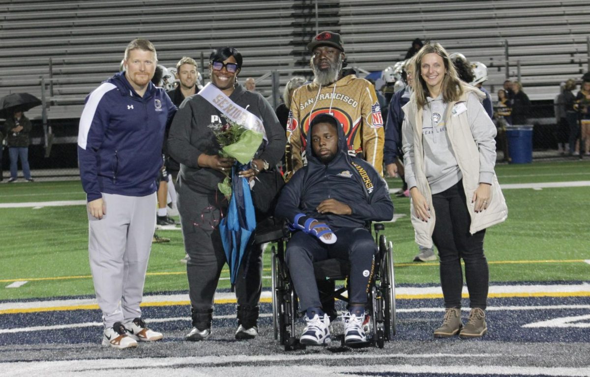 Jamarie Sanders was escorted by his parents Annita Patterson and Elmomar Sanders down the 50-yard line to gather with head coach James Yeager and principal Dr. Leslie Ittner for Senior Night. Senior Night was celebrated on Nov. 7, 2025, at Ocean Lakes High School.