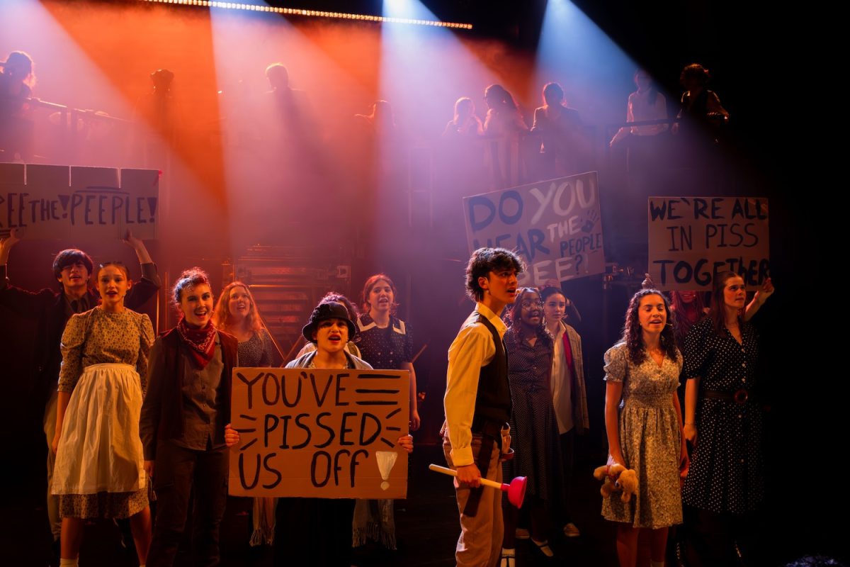 The “Urinetown” cast sings “Act One Finale.” The cast performed an open dress rehearsal for local senior citizens and teachers to watch Feb. 4.