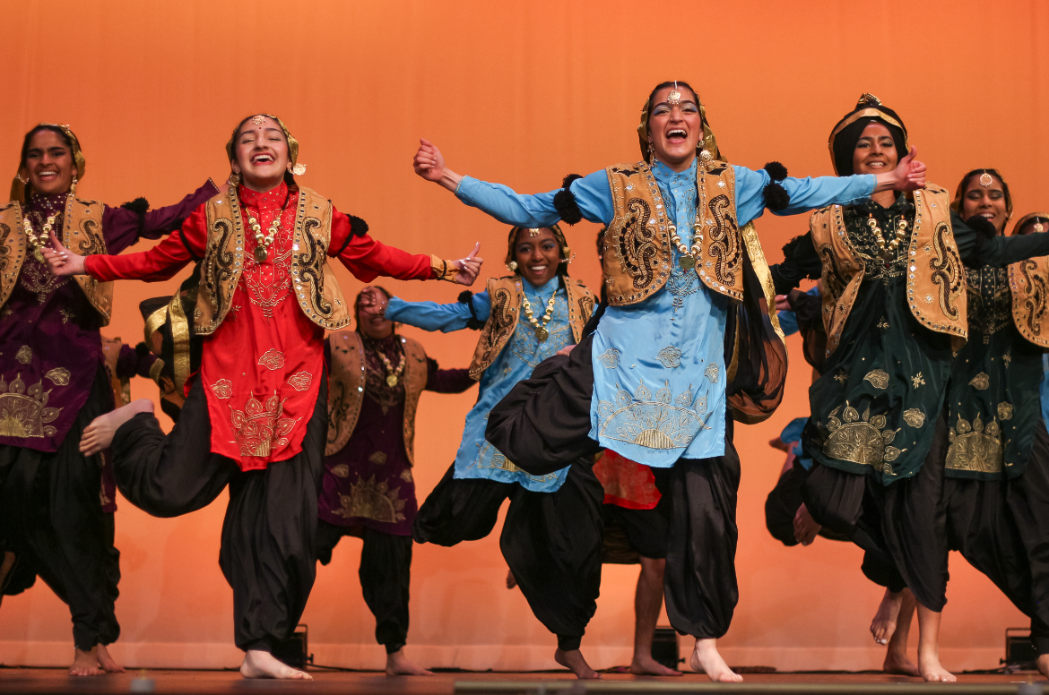 MVHS Bhangra dances in a group on the stage during a performance | Photo Courtesy of Kavyamridula Venkatesan  