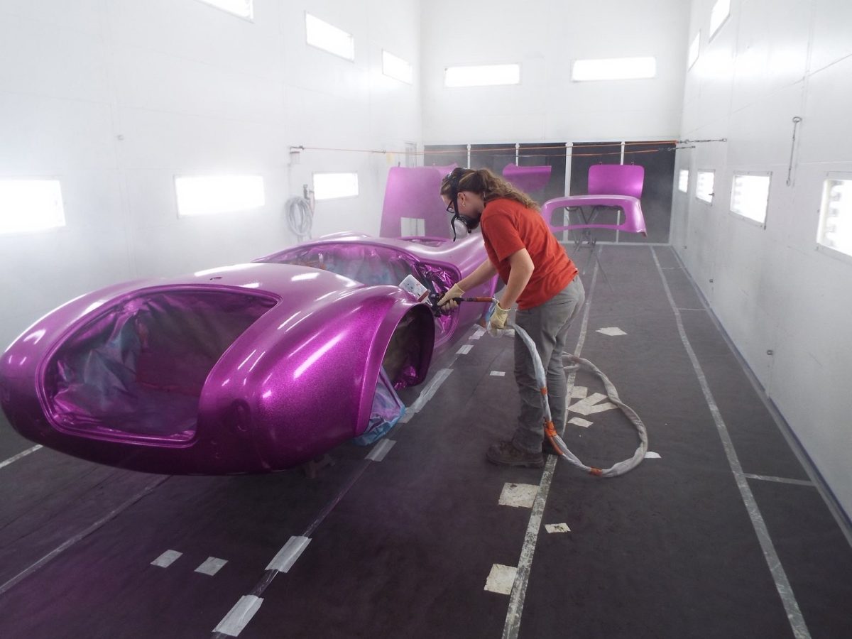 Anah Beschler spraying clearcoat on the Dragonsnake (photo courtesy of Rob Fichtner) 