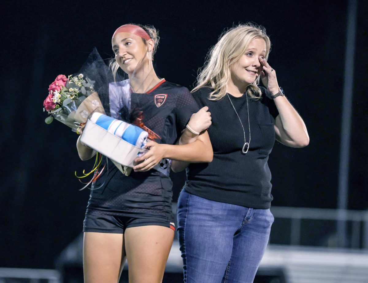 LINKED. Senior Abigayle Bates and her mom, Miranda Bates, stand at the soccer field in celebration of senior night at the home game against New Caney March 3. Abigayle gave a speech to the team about her soccer passion and dad. Miranda ran the soccer booster club the past four years.