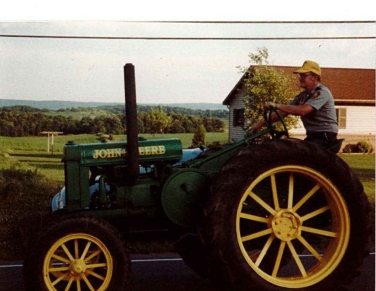 Tim Nowlin driving his classic John Deere tractor on the farm  (photo courtesy of Vanessa Nowlin)