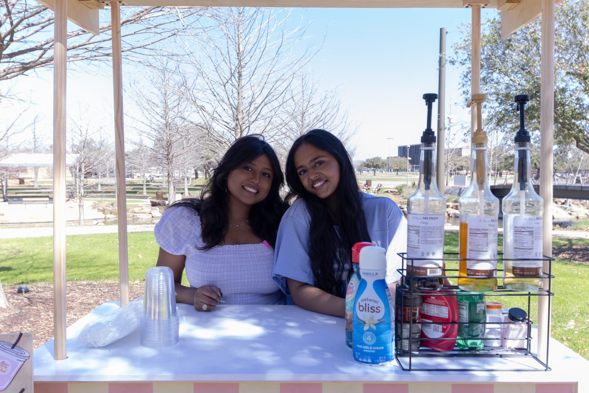 Supply chain management senior Neha Vajinapalli and electronic systems engineering technology senior Likitha Joneboina pose for a picture behind their cart at Aggie Park on Monday, March 2, 2026. (Theresa Lozano/The Battalion)