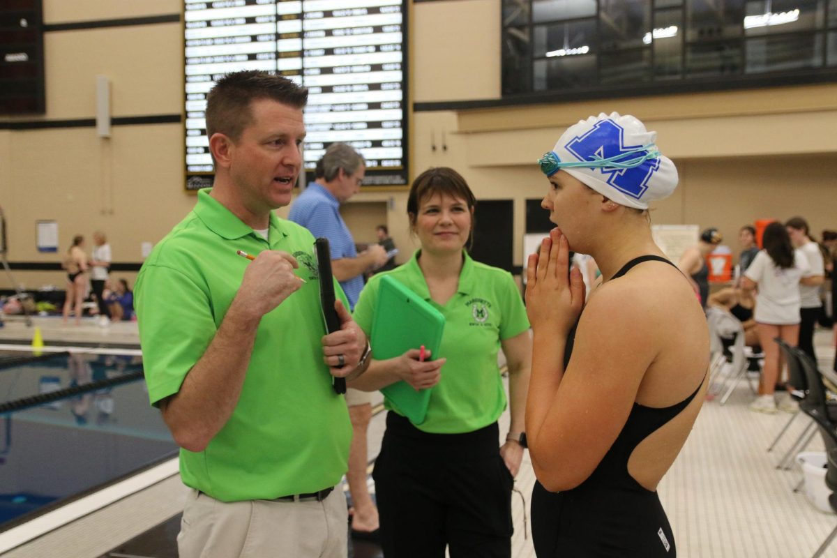 After her 2nd place finish in the 50-yard freestyle at the COMO Invitational on Saturday, Jan. 10, Paige Blom, junior, discussed her performance with Joeseph Schoedel, swim coach, and Katie Bauman, assistant swim coach. On Saturday, Feb. 21, Blom placed 1st at MSHSAA Girls State - Class 2 with a time of 23.98.