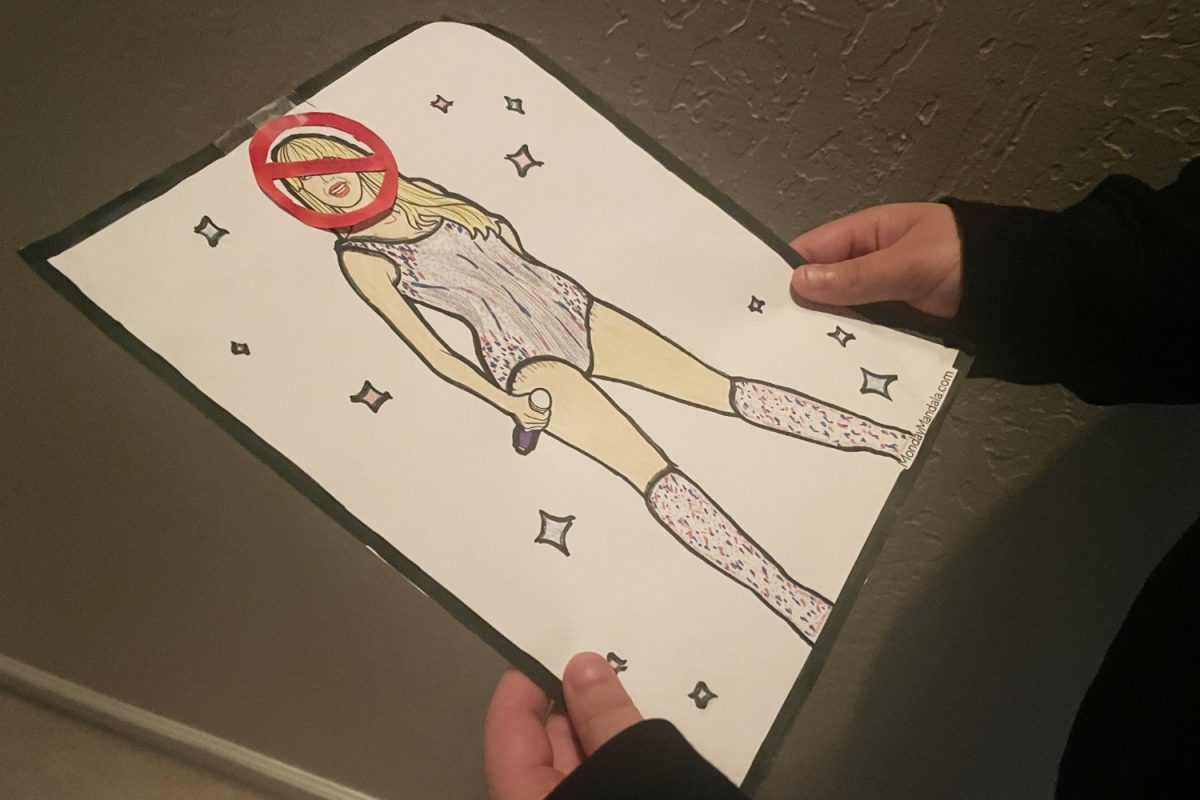 A student holds an image of Taylor Swift with a line through it. "I’ve always been around her music, and when I got older, I was able to appreciate it more. I like her lyrics,” said Lauren Ames, a sophomore at Sacred Heart Prep, describing how she grew to love Taylor Swift.