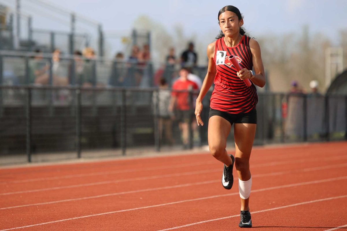 PUSH HARD. Senior Analily Organes runs the 4x4 relay Thursday, March 6. Organes pushed herself during this lap even though the team didn’t place what they wanted.