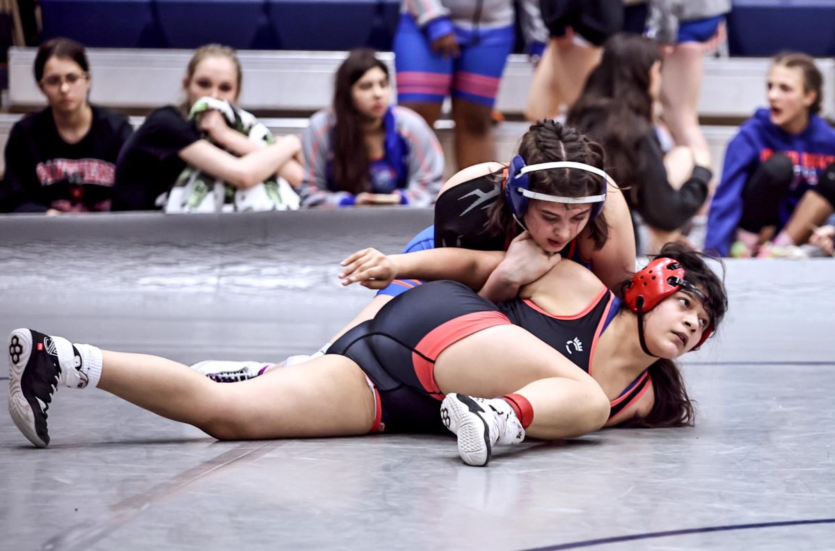 EYES ON THE PRIZE. Sophomore Princess Lopez looks to the clock while wrestling her opponent from Grand Oaks High School in the District 8-6A tournament Jan. 29. This was the second consecutive year Lopez qualified for the Region 2-A tournament.