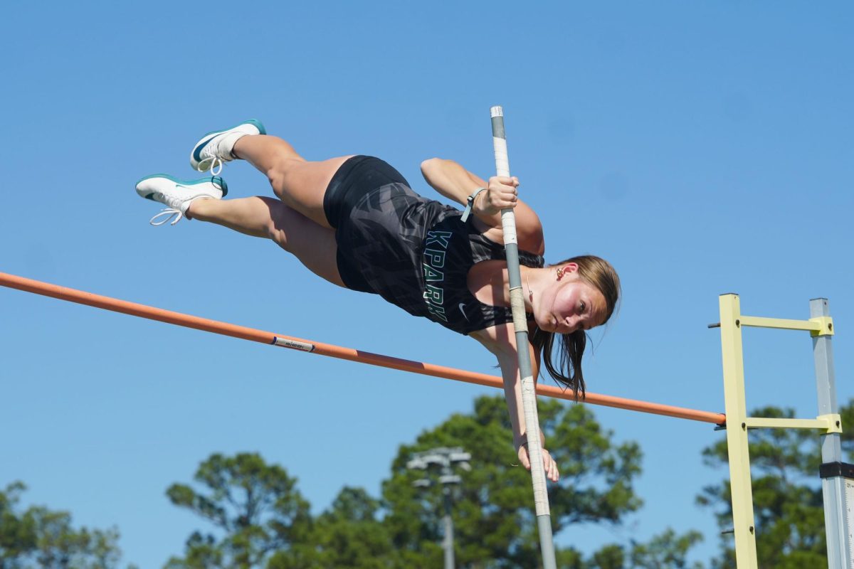 Senior Emilee Smith clears the bar during a home track meet on March 13. Smith, a 2025 state qualifier, won pole vault at the district meet by clearing 11-feet 6 inches on April 8. Track and field is the sport nationwide with the highest percentage of girls competing. 