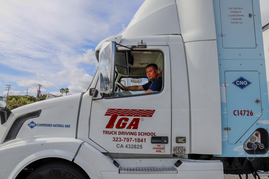 Christian Escoto, a truck driving instructor, drives a truck to set up skill training lessons for students on April 21 in El Camino College's parking Lot L. (Donovan Harris | Warrior Life)